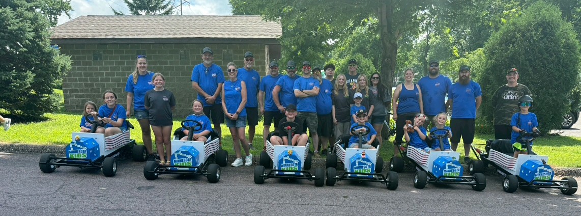 Minnesota Kids Foundation volunteers, families, children, and parade carts